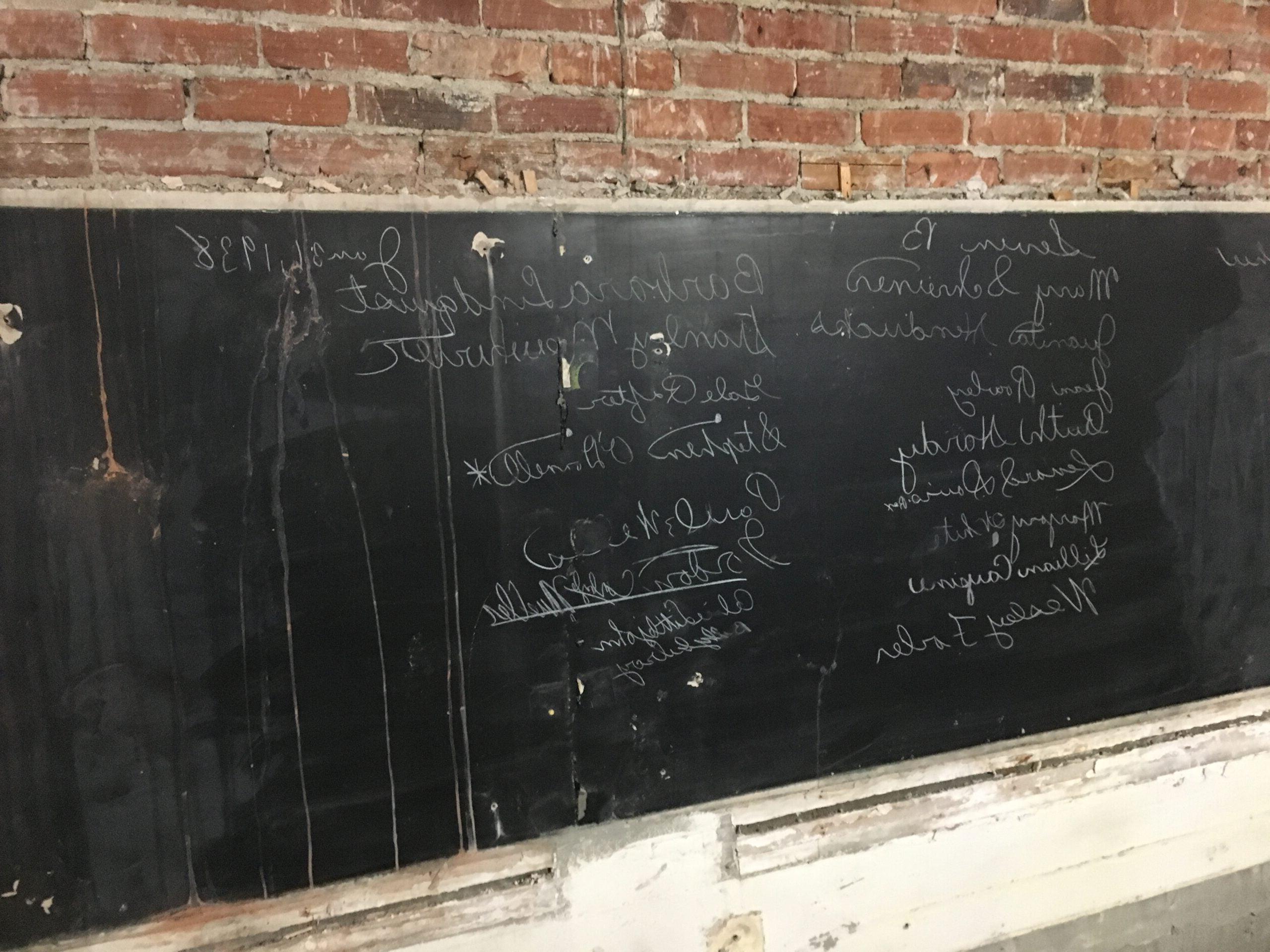 一块黑板上用粉笔写满了名字